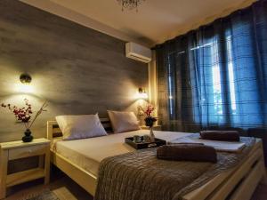 a bedroom with two beds and a window at Armonia Petra House in Kavála