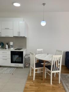 a kitchen and dining room with a table and chairs at Apartman A3 in Ulcinj +61 photos