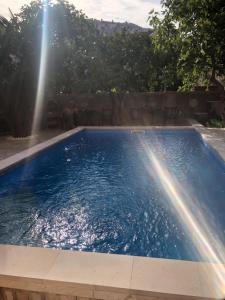 a swimming pool with two fountains in a yard at Villa Botticelli in Mostar