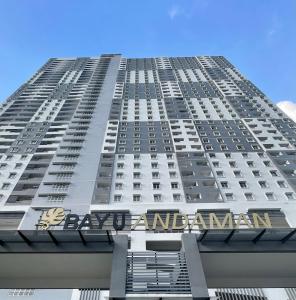 a tall building with a sign on the side of it at Bayu Andaman KL Centre in Kuala Lumpur