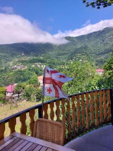 a flag on a balcony with a view of a mountain at Cottage house in K'eda