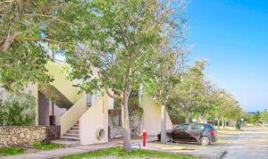a car parked in front of a house with trees at Ogi Seaside Gajac in Novalja +14 photos