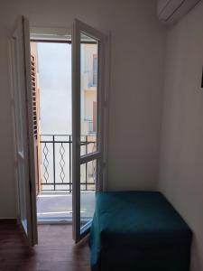 a room with a door open to a balcony at TRAPANI CITY SEA APARTMENT in Trapani
