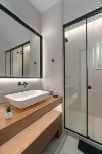 a bathroom with a sink and a glass shower at Elit Villa Psarou in Psarou