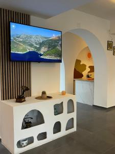 a living room with a tv on a wall at RÜYA BOHEME HOTEL BODRUM in Bodrum City