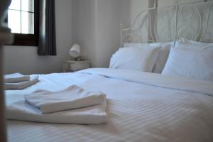 A bed or beds in a room at Aegean View House