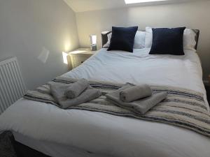 a large white bed with two pillows on it at First Floor One bedroom Apartment Quiet Location in Stafford in Stafford