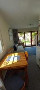 a living room with a bed and a wooden table at Gemütliche FeWo Bi-Uns in Gustow