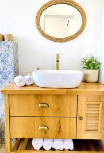 a bathroom with a sink and a mirror at היחידה ליד הנחל עם הנוף לחרמון 33 in Sede Neẖemya