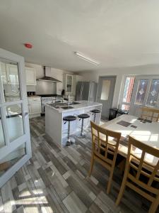 a kitchen with a table and chairs and a kitchen with a counter at Willow House in Birmingham