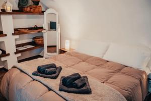 a bed with two pillows on it in a room at Rustico con SPA Privata - Piscina - Sauna - Hammam - Free Wi-Fi & NETFLIX in Brossasco