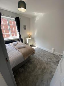 a bedroom with a bed and a window at Willow House in Birmingham