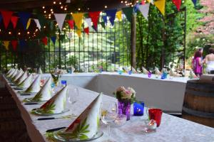 a row of tables with wine glasses and flags at Agriturismo Casa de Colores in Moretta