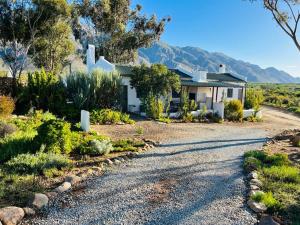 a house with a gravel road in front of it at 360on62 Farm Cottages in Montagu