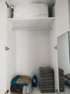 a closet with a bed and a mirror and towels at MyHome S1 At Seri Kembangan With A View in Seri Kembangan