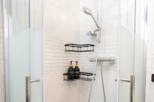 a shower with two bottles on a wall at Travelers Dream Heart of Mannheim in Mannheim