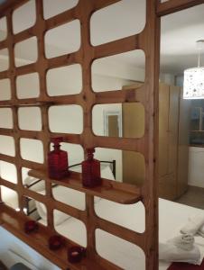 uno specchio su un muro con due candele rosse di Sand house 2 a Néa Péramos