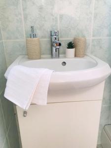 a white bathroom sink with a towel on it at Apartments Endji I in Čilipi