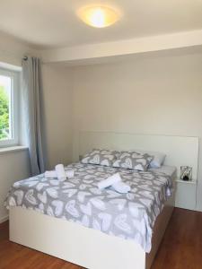 a bedroom with a bed with two towels on it at Apartments Endji I in Čilipi +11 photos