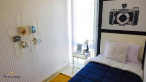 a bedroom with a bed with a camera on the wall at Villa Canyata in Pasuruan