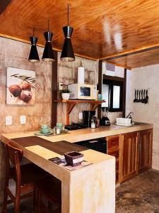 a kitchen with a table and a counter top at Xtambaa Cabins & Spa Only Adults in El Cuyo