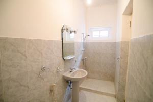 a bathroom with a sink and a shower at Irene's Home in Matale