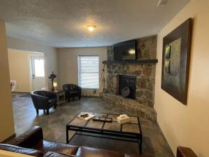 a living room with a couch and a fireplace at Scottish Inns Motel - Osage Beach in Osage Beach