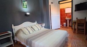 1 dormitorio con cama blanca y baño en Titrite Ouzoud en Ouzoud