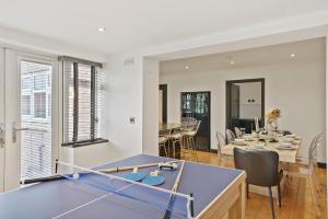 a living room with a ping pong table and a dining room at 5 Star Lux Coastal Gem - Indoor Heated Pool - Pets in Filey