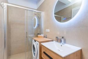 a bathroom with a sink and a washing machine at Apartments Ivanka Cres in Cres