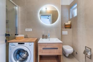 a bathroom with a washing machine and a sink at Apartments Ivanka Cres in Cres