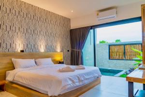 una camera con un grande letto e una grande finestra di R resident resort a Phetchaburi