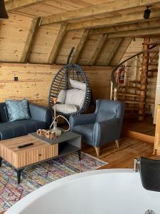 Orca Bungalows في أرديسن: غرفة معيشة مع أريكة وكرسي