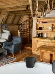 a living room with a chair and a table at Orca Bungalows in Ardeşen