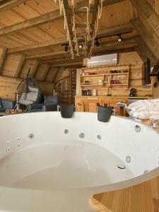 a white bath tub in a room with wooden ceilings at Orca Bungalows in Ardeşen