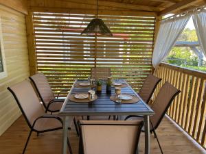 a table and chairs on the porch of a cabin at LunaBay Biograd Mobile Home in Biograd na Moru