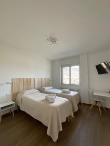 a bedroom with two beds and a desk and a sink at Settimo Cielo Apartment Aosta CIR 0199 in Aosta