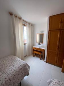 a bedroom with a bed and a dresser and a window at Tazacortes Beach and also Luz y Mar apartments in Puerto