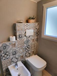 a bathroom with a toilet and a sink at Ca' Balenga - Cozy Stay in the Old Town with Free Private Parking in Asti