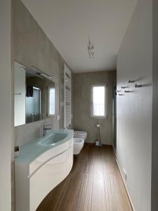 a bathroom with a tub and a toilet and a sink at Settimo Cielo Apartment Aosta CIR 0199 in Aosta