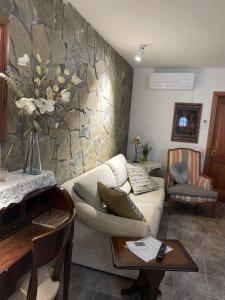 ein Wohnzimmer mit einem weißen Sofa und einer Steinmauer in der Unterkunft Beautiful apartment in Tossa de Mar in Tossa de Mar