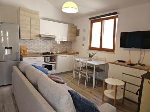 a living room with a couch and a kitchen at Matija in Medulin