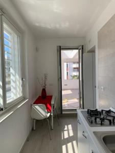 a kitchen with a stove and a table and a window at Casa vacanze in Volla