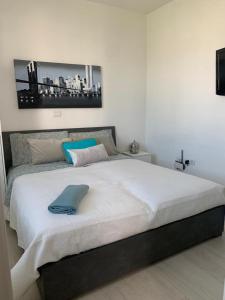 a bed with a blue pillow on top of it at Casa vacanze in Volla