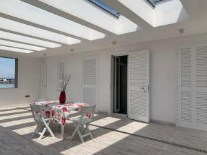 a table and chairs on a patio with a vase on it at Casa vacanze in Volla