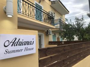 a sign for a summer house on the side of a building at Adriana's Summer House in Kassiopi