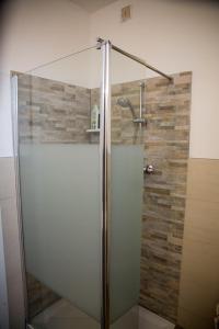 a shower with a glass door in a bathroom at Bed & Breakfast Delle Rose in Conegliano