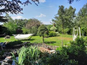 a garden with a hammock and a swing at Pod Wierzbą Apartament na Kaszubach 