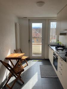a kitchen with a table and chairs and a window at 1 BDR Apartment in Zurich West in Zurich