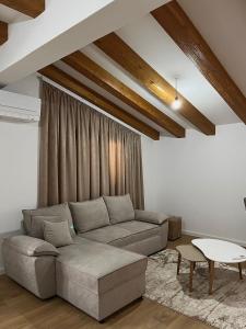 a living room with a couch and a table at Albanian Traditions Legacy in Durrës